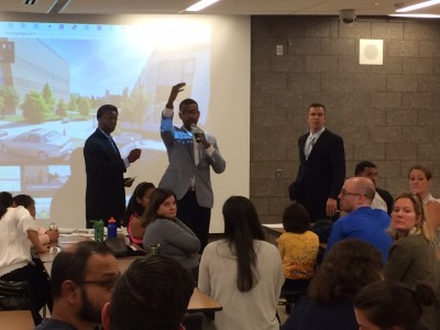 Principals from Jenner Academy for the Arts, center, and Ogden International School, right, speak to Ogden parents about a possible merger. The proposal would integrated a neighborhood public housing school for the first time in Chicago.